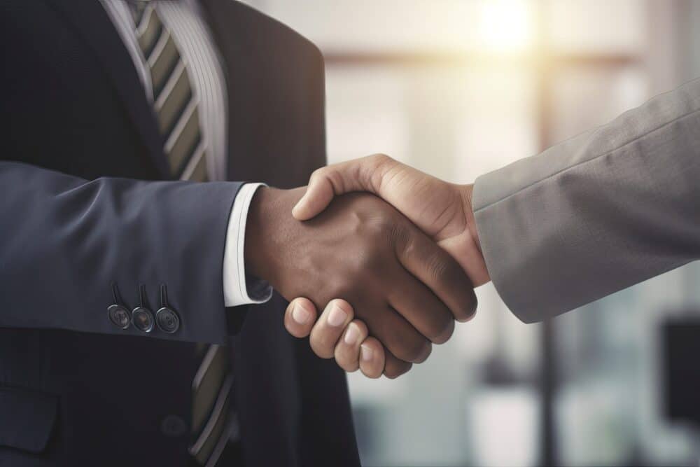 Attorneys shaking hands in the office Local Counsel at Wheeler Upham, Attorneys, Grand Rapids, Michigan